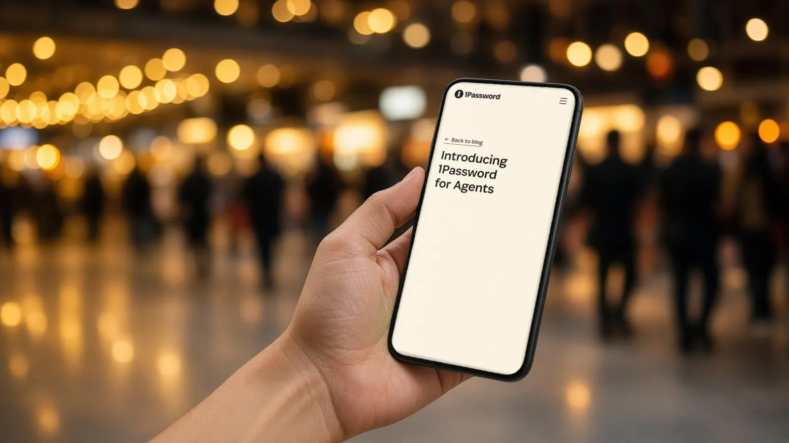 Hand holding a phone in a station concourse showing 1Password's blog post about 1Password for AI agents